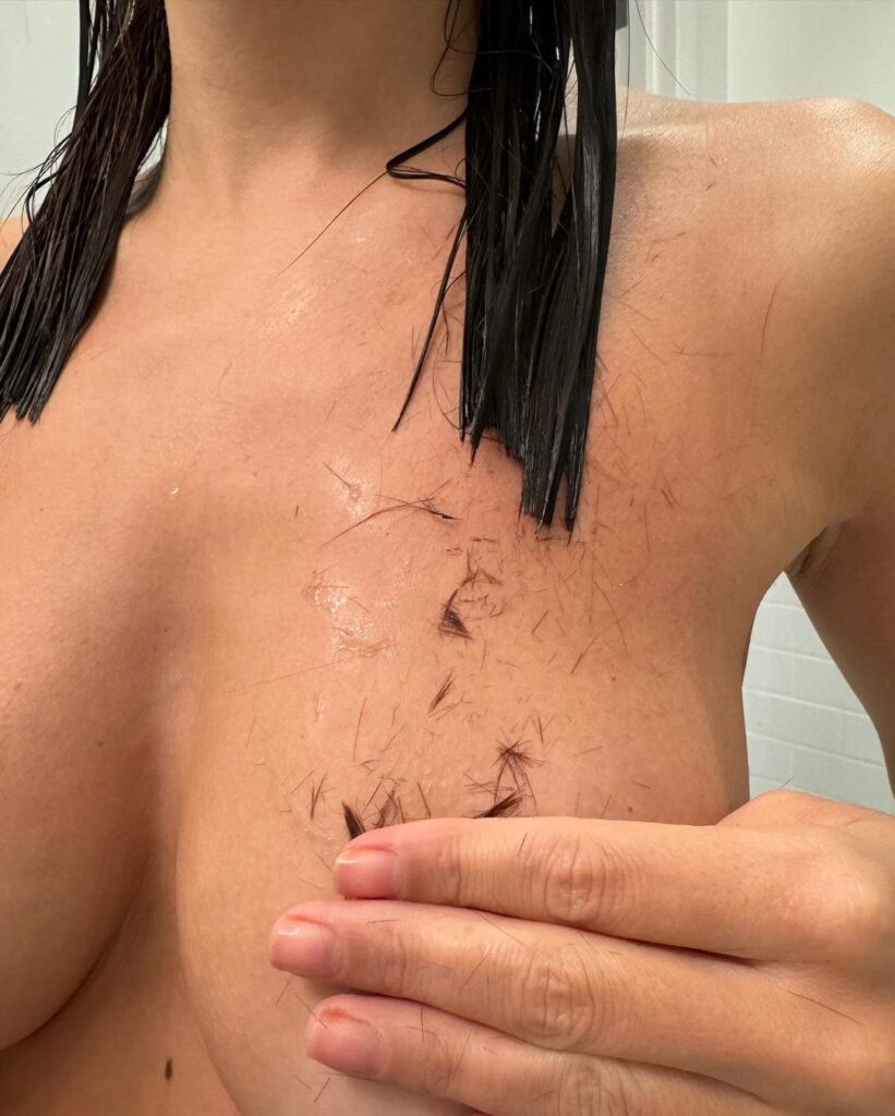 Emily Ratajkowski shares topless shot while cutting her own hair,