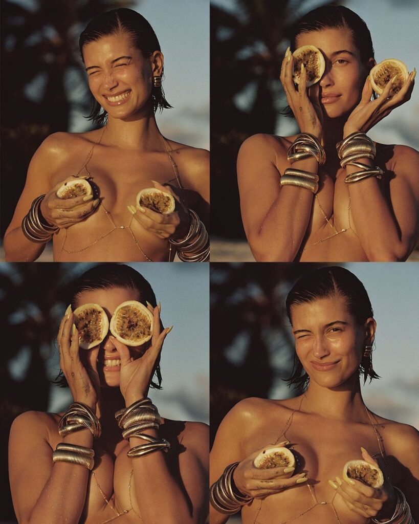 Hailey Bieber stripped down to her jewels, using a passion fruit as a playful prop
